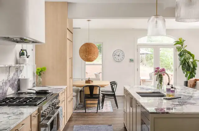Arlington, VA kitchen remodel with light oak cabinets, purple-veined stone counters, a woven rattan pendant and a breakfast table by French doors