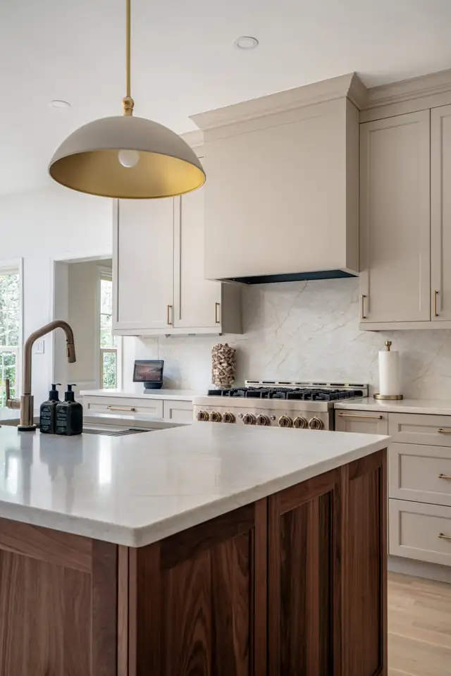 McLean kitchen with a walnut island, white quartz top and a brass dome pendant